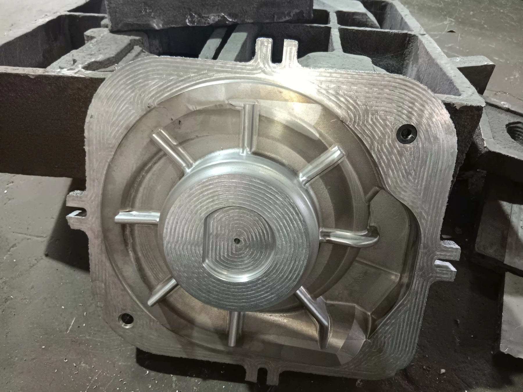 Angled view of a machined aluminium pattern with visible tool paths