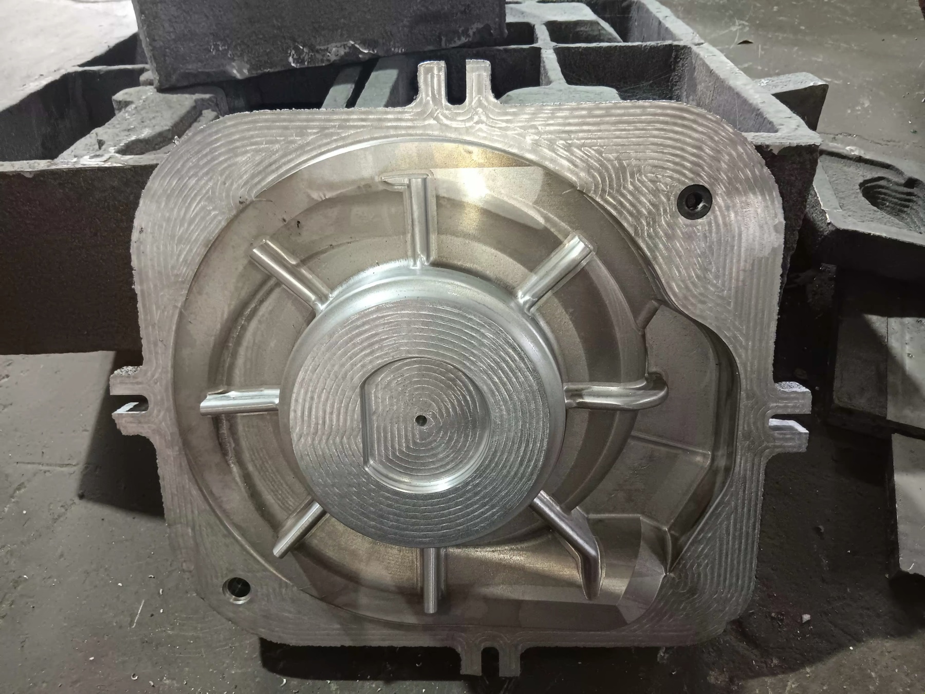 Front view of a machined aluminium pattern with radial ribs